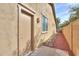 Side view of home's exterior showcasing a private entrance and well-maintained landscaping at 325 W Seaside Dr, Casa Grande, AZ 85122