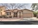 Charming single-story home featuring a two-car garage, desert landscaping, and a welcoming entryway at 325 W Seaside Dr, Casa Grande, AZ 85122