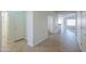 Bright hallway with tile flooring, leading to multiple rooms and featuring neutral paint at 325 W Seaside Dr, Casa Grande, AZ 85122