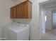 Laundry room with a washer and dryer, storage cabinets, and tile flooring at 325 W Seaside Dr, Casa Grande, AZ 85122