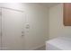 Laundry room with a washer and dryer hookup, storage cabinet, and tile flooring at 325 W Seaside Dr, Casa Grande, AZ 85122