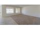 Bright living room with tile/carpet flooring and large windows for natural light at 325 W Seaside Dr, Casa Grande, AZ 85122