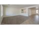 Spacious living room featuring neutral carpet and view of the front door at 325 W Seaside Dr, Casa Grande, AZ 85122