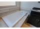 Bathtub featuring tile surround, silver fixtures, and a small window for natural light at 32960 N 70Th St, Scottsdale, AZ 85266