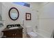 Well lit bathroom featuring a dark wood vanity and a shower-over-tub enclosure at 32960 N 70Th St, Scottsdale, AZ 85266