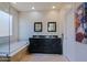 Bright bathroom featuring double sinks, modern fixtures, and a glass enclosed bathtub at 32960 N 70Th St, Scottsdale, AZ 85266
