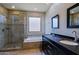 Well-lit bathroom featuring double sinks, a glass enclosed shower, and a soaking tub at 32960 N 70Th St, Scottsdale, AZ 85266