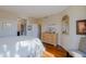 Bedroom featuring hardwood floors, a dresser, and a queen bed with neutral bedding at 32960 N 70Th St, Scottsdale, AZ 85266