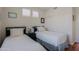 Cozy bedroom featuring hardwood floors and two twin beds beneath shuttered windows at 32960 N 70Th St, Scottsdale, AZ 85266