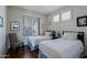 Bright bedroom with hardwood floors, white walls, and two twin beds under shuttered windows at 32960 N 70Th St, Scottsdale, AZ 85266