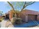 Cozy desert home with private two-car garage surrounded by decorative rock and drought-resistant plants at 32960 N 70Th St, Scottsdale, AZ 85266