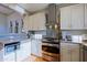 Well-equipped kitchen features granite counters, stainless appliances, and ample white cabinets at 32960 N 70Th St, Scottsdale, AZ 85266