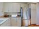 Functional kitchen with stainless steel fridge, granite counters, and abundant cabinet space at 32960 N 70Th St, Scottsdale, AZ 85266