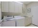Functional laundry room offers modern washer/dryer, sink, and plenty of storage at 32960 N 70Th St, Scottsdale, AZ 85266