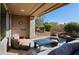 Charming outdoor patio area with cozy seating, a fire pit table, and desert landscaping at 32960 N 70Th St, Scottsdale, AZ 85266