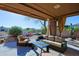 Inviting covered patio with comfortable seating and desert landscaping, perfect for relaxation at 32960 N 70Th St, Scottsdale, AZ 85266
