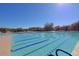 Full shot of a lap pool under a clear sky, with lounge areas alongside at 32960 N 70Th St, Scottsdale, AZ 85266