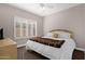 Relaxing bedroom with large window, ceiling fan, and plush carpet at 33250 N 71St St, Scottsdale, AZ 85266
