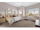 Spacious bedroom with plantation shutters, large bed, and plush carpet at 33250 N 71St St, Scottsdale, AZ 85266