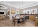 Dining area with decorative lighting, gas fireplace, and an oval table with seating for six at 33250 N 71St St, Scottsdale, AZ 85266