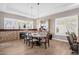 Elegant dining room with a fireplace, wood floors, and stylish light fixtures above the table at 33250 N 71St St, Scottsdale, AZ 85266