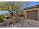 Well-manicured desert landscaping surrounds this charming single-story home with an attached two-car garage at 33250 N 71St St, Scottsdale, AZ 85266