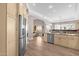 Spacious kitchen featuring a large island with a stainless steel refrigerator and view into the living room at 33250 N 71St St, Scottsdale, AZ 85266