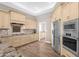 Gourmet kitchen with custom cabinetry, stainless steel appliances, and a cooktop on a granite countertop at 33250 N 71St St, Scottsdale, AZ 85266
