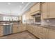Open kitchen with stainless appliances, custom cabinets, and granite countertops with barstool seating at 33250 N 71St St, Scottsdale, AZ 85266
