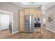 Kitchen area with stainless steel refrigerator and oven with view of the laundry room at 33250 N 71St St, Scottsdale, AZ 85266