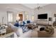 Spacious living room with comfortable seating, a decorative ottoman, and ample natural light at 33250 N 71St St, Scottsdale, AZ 85266