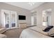 Spacious bedroom with plantation shutters, TV, and patio access at 33250 N 71St St, Scottsdale, AZ 85266