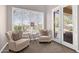 Sitting area with plantation shutters, accent chairs, and patio access at 33250 N 71St St, Scottsdale, AZ 85266
