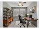 Home office featuring a modern desk, comfortable chair, and built-in shelving with natural light at 3369 E Penedes Dr, Gilbert, AZ 85298