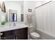 Standard full bathroom with dark brown cabinets and white shower curtain at 35285 W San Pedro Dr, Maricopa, AZ 85138