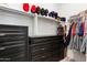 Walk-in closet with custom shelving, drawers and space for hanging clothing at 35285 W San Pedro Dr, Maricopa, AZ 85138