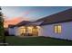 Exterior home view with a covered patio, manicured lawn, and colorful sunset at 3634 N 47Th St, Phoenix, AZ 85018