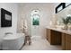 Luxurious bathroom featuring a soaking tub, tiled shower, and elegant fixtures at 3634 N 47Th St, Phoenix, AZ 85018