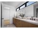 Bathroom with dual sinks, quartz countertops, modern fixtures, and large mirrors at 3634 N 47Th St, Phoenix, AZ 85018