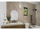 Bathroom featuring sleek fixtures, contemporary finishes, and a window providing natural light at 3634 N 47Th St, Phoenix, AZ 85018