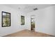 Bright bedroom with hardwood floors, white walls, black trim windows, and an ensuite bathroom at 3634 N 47Th St, Phoenix, AZ 85018