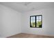 Bedroom with hardwood floors, white walls, black trim windows, and a ceiling fan at 3634 N 47Th St, Phoenix, AZ 85018