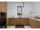 Well-organized laundry room with custom cabinetry, modern appliances, and a stylish design at 3634 N 47Th St, Phoenix, AZ 85018