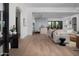 Bright, open-concept living room flows into the kitchen, featuring hardwood floors and modern decor at 3634 N 47Th St, Phoenix, AZ 85018