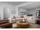 Spacious living room open to the kitchen with a round wood table, neutral colors and modern decor at 3634 N 47Th St, Phoenix, AZ 85018