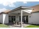 Inviting covered patio with a dining table, modern lighting, and manicured landscaping at 3634 N 47Th St, Phoenix, AZ 85018