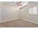 Bedroom with neutral carpet, ceiling fan, and bright window at 3644 W Townley Ave, Phoenix, AZ 85051