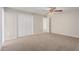 Spacious carpeted bedroom features a ceiling fan and a large closet for ample storage at 3644 W Townley Ave, Phoenix, AZ 85051