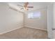 Bright bedroom with tan brick walls, a ceiling fan, and a large window for lots of light at 3644 W Townley Ave, Phoenix, AZ 85051
