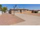 Single-story brick home with a basketball hoop and long driveway, offering a welcoming curb appeal at 3644 W Townley Ave, Phoenix, AZ 85051